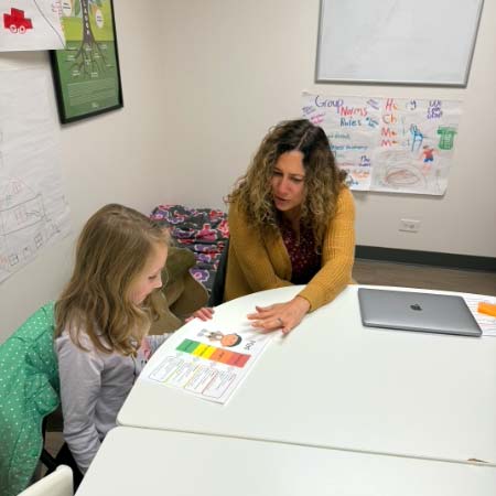 Comprehensive SLP's Karen Lapinski working with a young client.